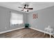 Cozy bedroom with luxury vinyl plank flooring, modern ceiling fan and bright natural light at 3334 N Westmoreland Dr, Orlando, FL 32804