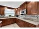 This kitchen features granite countertops, tile backsplash, stainless steel microwave and beautiful wood cabinetry at 3334 N Westmoreland Dr, Orlando, FL 32804