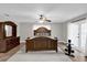 Bright main bedroom with a wood bed frame, wood flooring and large windows overlooking the backyard at 3334 N Westmoreland Dr, Orlando, FL 32804