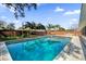 Inviting backyard pool with lush landscaping and a barbecue area, perfect for relaxation and outdoor entertainment at 3334 N Westmoreland Dr, Orlando, FL 32804