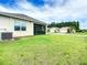 Private backyard with a screened patio and lush green lawn at 367 Caryota Ct, New Smyrna Beach, FL 32168