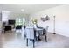 Bright dining area with a round table and gray chairs near a patio at 367 Caryota Ct, New Smyrna Beach, FL 32168