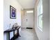 Bright and airy foyer with tile flooring and a console table at 367 Caryota Ct, New Smyrna Beach, FL 32168