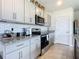 Modern kitchen with gray cabinets and granite countertops at 367 Caryota Ct, New Smyrna Beach, FL 32168