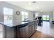 Kitchen island with granite countertop and stainless steel dishwasher at 367 Caryota Ct, New Smyrna Beach, FL 32168