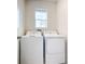 Laundry room with washer and dryer in a light and airy space at 367 Caryota Ct, New Smyrna Beach, FL 32168