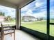 Relaxing screened porch overlooking a grassy backyard and neighborhood at 367 Caryota Ct, New Smyrna Beach, FL 32168