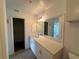 Modern bathroom with double vanity and large mirror at 3724 Castle Pines Ln # 4237, Orlando, FL 32839