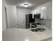 Modern kitchen with breakfast bar, white cabinets, and stainless steel appliances at 3724 Castle Pines Ln # 4237, Orlando, FL 32839