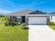 Curb appeal abounds in this charming one-story home, featuring a stone facade and red shutters at 3842 Whitetail Ct, St Cloud, FL 34772