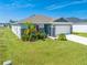 One-story home with gray siding, stone accents, and a two-car garage at 3842 Whitetail Ct, St Cloud, FL 34772