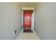 Inviting entryway with a bright red door and a welcoming 