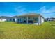 Single-story house with covered patio and grassy backyard at 3842 Whitetail Ct, St Cloud, FL 34772