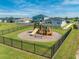 Community playground with a fenced play area at 3842 Whitetail Ct, St Cloud, FL 34772