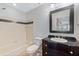 Bathroom with tub, toilet, dark vanity, and mirror at 4302 Clubside Dr # 4302, Longwood, FL 32779