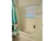 Clean bathroom with a tub, shower curtain, and white tile at 4563 Yellowgold E Rd # 108, Kissimmee, FL 34746