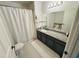 Clean bathroom with granite countertop, updated vanity, and shower/tub combo at 4563 Yellowgold E Rd # 108, Kissimmee, FL 34746