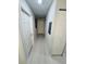 Light-colored hallway with multiple doors and wood-look floors at 4563 Yellowgold E Rd # 108, Kissimmee, FL 34746