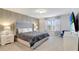 Main bedroom with wood-like wall and TV at 4587 Terrasonesta Dr, Davenport, FL 33837