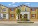 Two-story townhome with red shutters and landscaped front yard at 4587 Terrasonesta Dr, Davenport, FL 33837