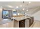 Modern kitchen island with granite countertops and stainless steel dishwasher at 4587 Terrasonesta Dr, Davenport, FL 33837