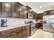 Kitchen boasts dark cabinetry, granite counters, and stainless steel appliances at 4587 Terrasonesta Dr, Davenport, FL 33837