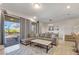 Living room with sectional sofa, coffee table, and sliding doors to patio at 4587 Terrasonesta Dr, Davenport, FL 33837