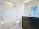 Clean bathroom with white tile, bathtub, toilet, and dark vanity at 459 Windmill Palm Cir, Altamonte Springs, FL 32701