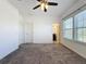 Bedroom with three windows, ceiling fan, and bathroom access at 459 Windmill Palm Cir, Altamonte Springs, FL 32701