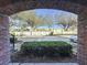 View of the parking lot through a brick archway at 459 Windmill Palm Cir, Altamonte Springs, FL 32701