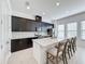 Modern kitchen with dark cabinetry, quartz countertops, and island at 459 Windmill Palm Cir, Altamonte Springs, FL 32701