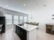 Open kitchen with large island, white countertops and dark cabinets at 459 Windmill Palm Cir, Altamonte Springs, FL 32701