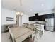 Modern kitchen with white quartz island and dark cabinets at 459 Windmill Palm Cir, Altamonte Springs, FL 32701