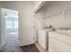 Bright laundry room includes a washer, dryer and extra shelving at 459 Windmill Palm Cir, Altamonte Springs, FL 32701