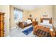 Bedroom with two twin beds, wood furniture, and nautical decor at 5012 Shoreway Loop # 30307, Orlando, FL 32819