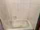 White tiled shower/tub combo in need of cleaning at 560 Garden Heights Dr, Winter Garden, FL 34787