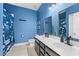 Bathroom with double vanity, ocean theme, and shower/tub at 568 Seattle Slew Dr, Davenport, FL 33837