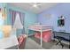 bedroom with loft bed, desk, and soft pink decor at 568 Seattle Slew Dr, Davenport, FL 33837