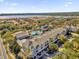 Aerial view of colorful condo community featuring a community pool, lake views, and lush landscaping at 6413 Astor Village Ave # 313, Orlando, FL 32835