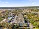 Aerial view of a condo community showcasing colorful buildings, a community pool, and lush surroundings at 6413 Astor Village Ave # 313, Orlando, FL 32835