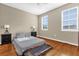 Inviting bedroom featuring hardwood floors and abundant natural light at 6413 Astor Village Ave # 313, Orlando, FL 32835