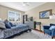 Comfortable bedroom with a light color scheme featuring a large window and gray dresser with an wall art accent at 6413 Astor Village Ave # 313, Orlando, FL 32835