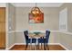 Cozy dining area with round table and two blue chairs, hardwood floor at 6413 Astor Village Ave # 313, Orlando, FL 32835