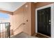 Inviting entryway with a modern black door and neutral-colored walls at 6413 Astor Village Ave # 313, Orlando, FL 32835