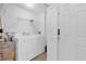 Convenient laundry room with washer, dryer, and extra shelving at 6413 Astor Village Ave # 313, Orlando, FL 32835