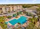 Aerial view of a resort-style community pool with lush landscaping and seating areas perfect for relaxation at 6413 Astor Village Ave # 313, Orlando, FL 32835