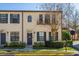 Tan two-story townhome with dark shutters, balcony, and manicured landscaping at 757 Siena Palm Dr # 757, Celebration, FL 34747