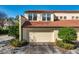 Attached garage with white door and landscaping at 757 Siena Palm Dr # 757, Celebration, FL 34747