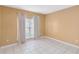 Bedroom with tile floors, neutral walls, and window with curtains at 7812 Wicklow Cir, Orlando, FL 32817