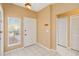 Inviting entryway with neutral walls, tiled floors, and natural light from the window at 7812 Wicklow Cir, Orlando, FL 32817